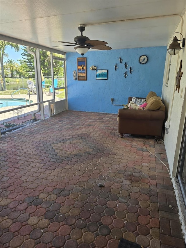 interior space with ceiling fan