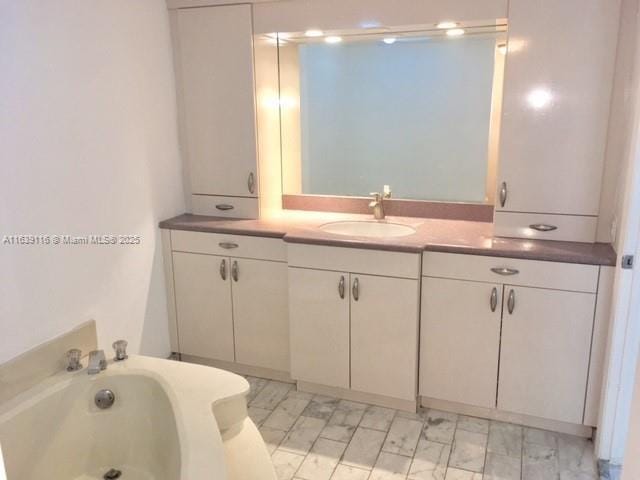 bathroom with a bathtub and vanity