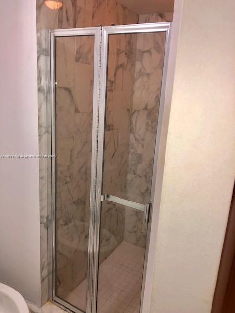 bathroom with a shower with shower door