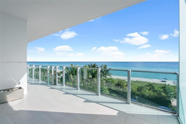 balcony with a view of the beach and a water view