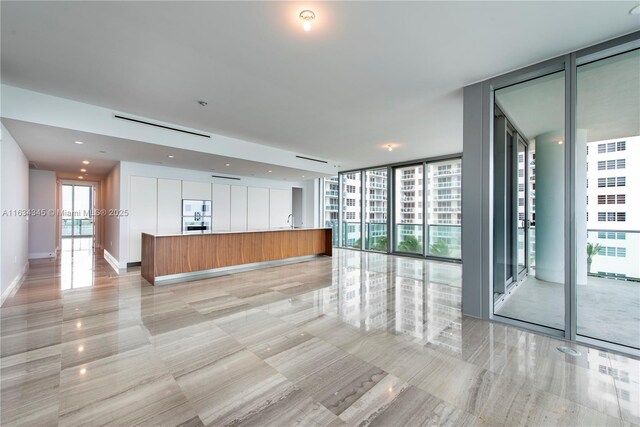 interior space featuring expansive windows and sink