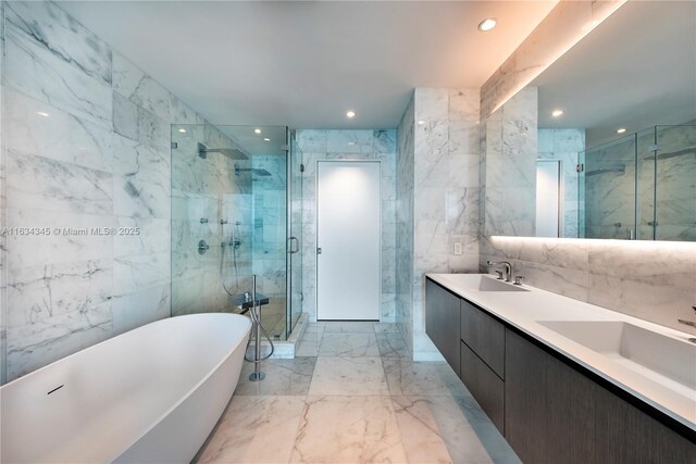 bathroom with vanity, tile walls, and shower with separate bathtub