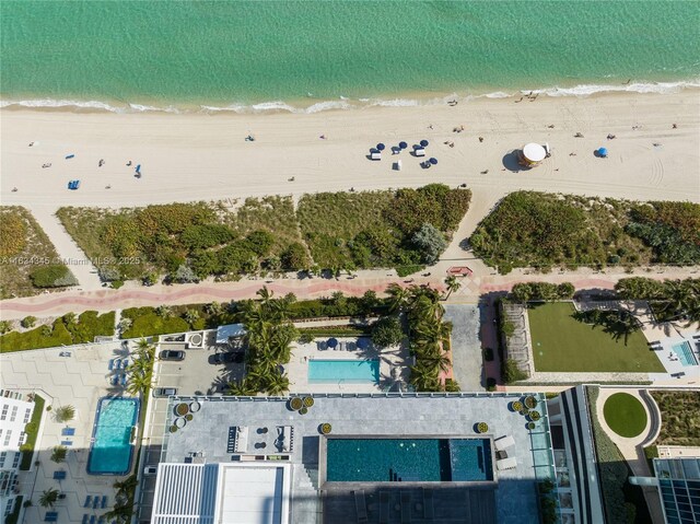 drone / aerial view with a water view and a beach view