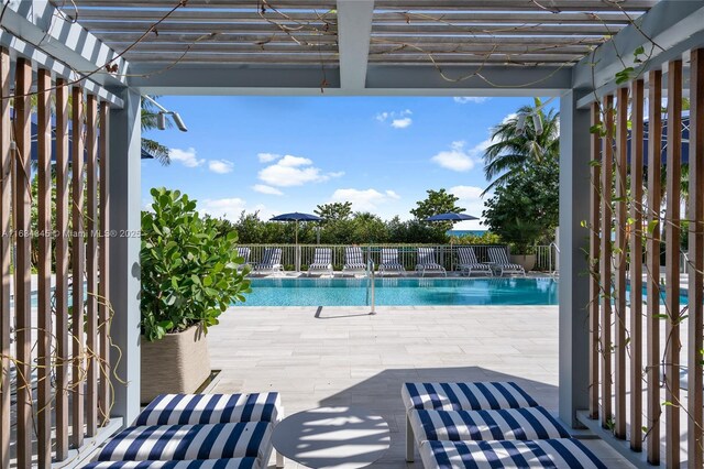 view of swimming pool featuring a patio area and a pergola