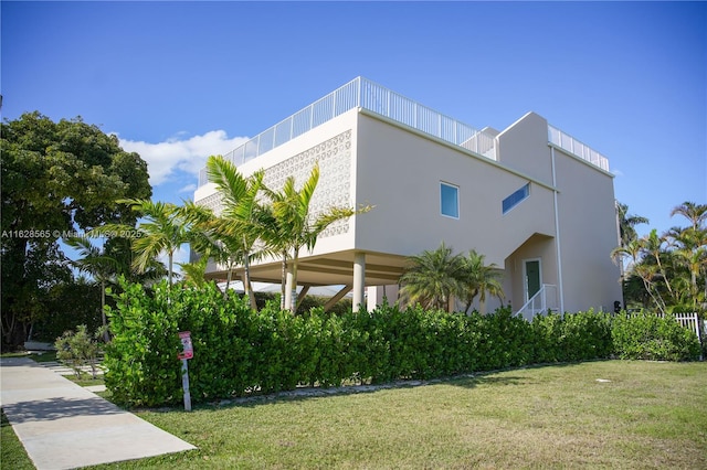 view of side of home with a lawn