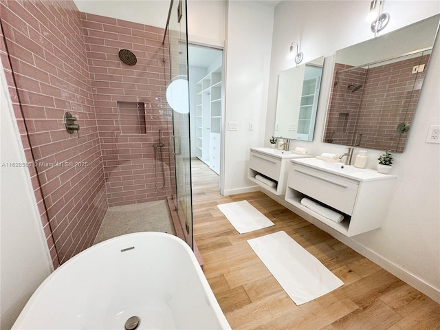 bathroom with vanity, wood-type flooring, and separate shower and tub