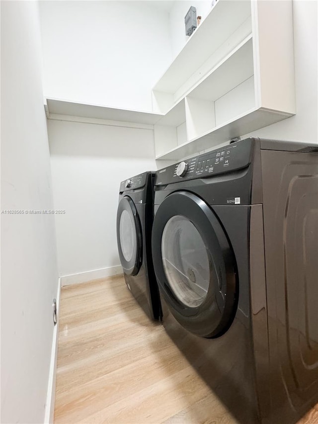 laundry area featuring light hardwood / wood-style floors and washer and dryer