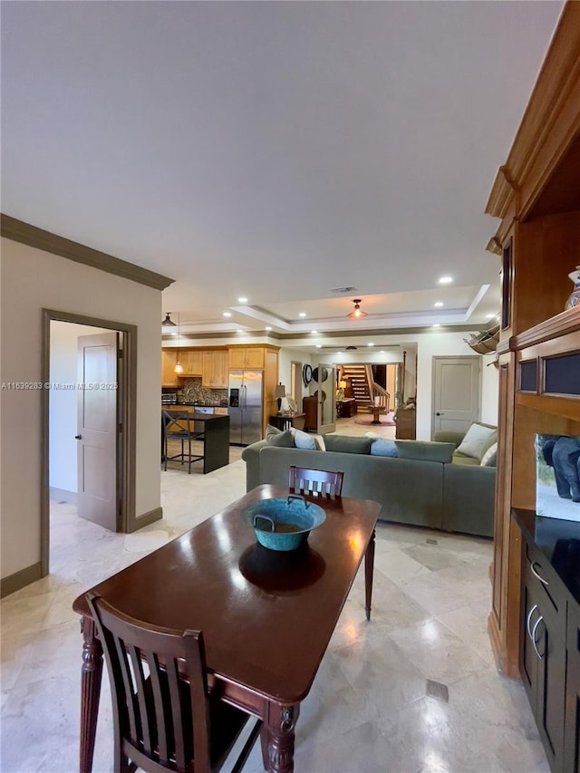 dining area featuring recessed lighting, visible vents, baseboards, a raised ceiling, and crown molding