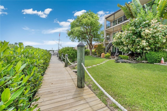 surrounding community with a lawn and a dock