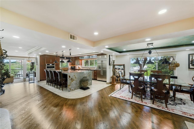 kitchen featuring light wood-style floors, visible vents, a kitchen island, and appliances with stainless steel finishes