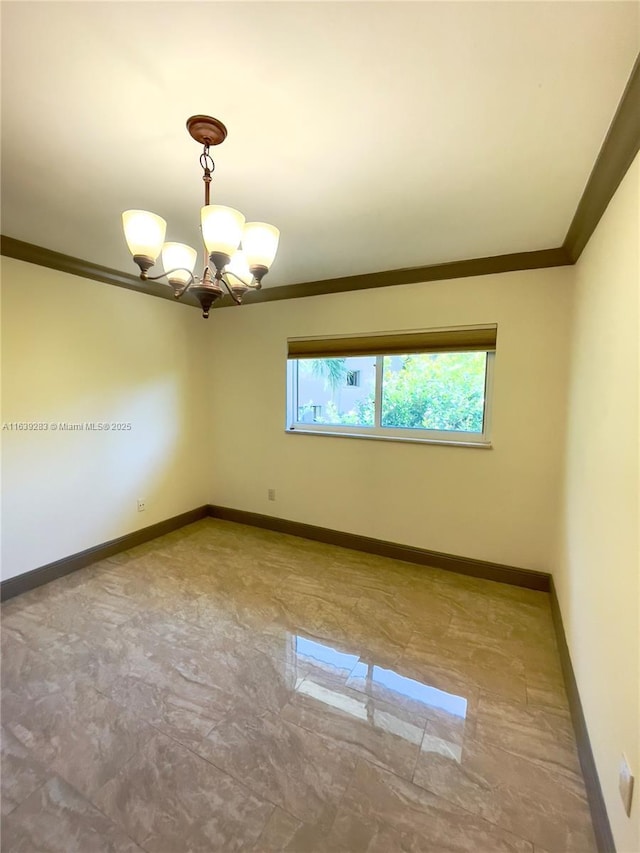 unfurnished room with marble finish floor, ornamental molding, an inviting chandelier, and baseboards