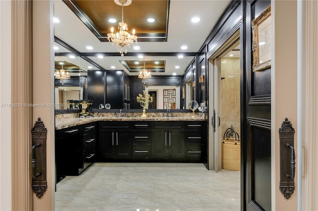 full bath featuring an inviting chandelier, recessed lighting, a tray ceiling, and vanity