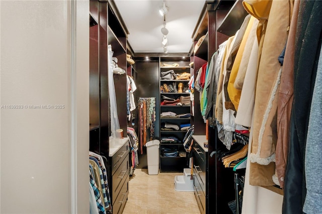 walk in closet featuring light tile patterned flooring