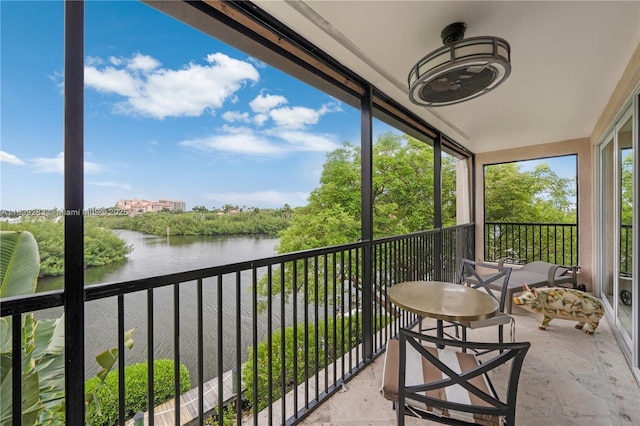 balcony with a sunroom and a water view