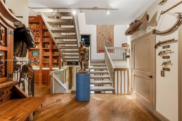 stairway with wood finished floors