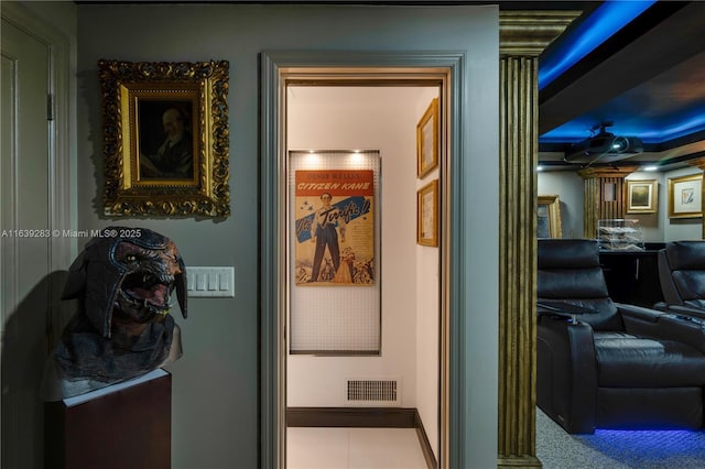 hallway featuring visible vents and baseboards