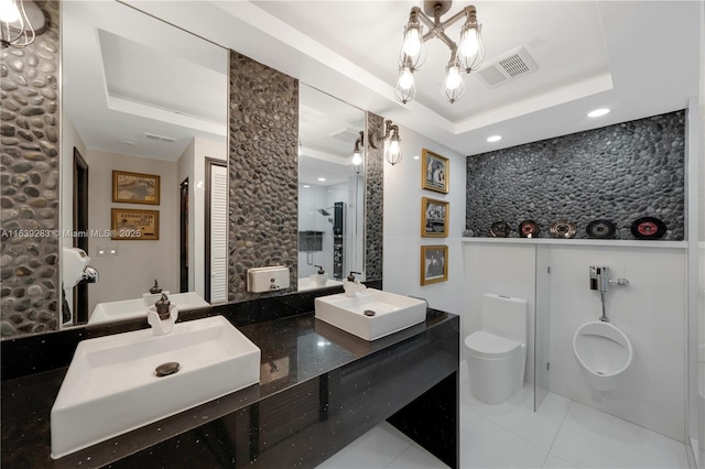 full bathroom featuring a walk in shower, a tray ceiling, a sink, and visible vents