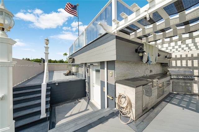 view of patio featuring a sink, area for grilling, and a grill