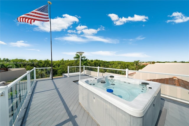 wooden deck with a hot tub