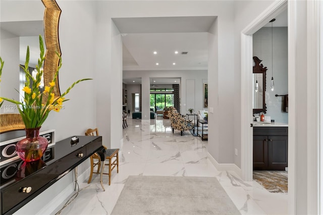 entrance foyer with ornamental molding and sink