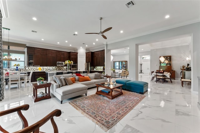 living room featuring ceiling fan and crown molding