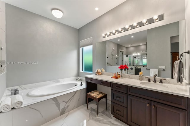 bathroom featuring vanity and independent shower and bath