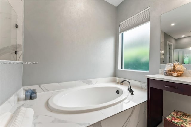 bathroom featuring vanity and shower with separate bathtub