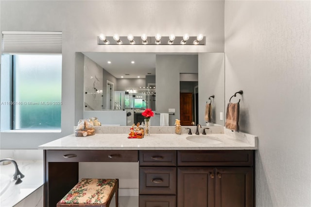 bathroom featuring vanity and shower with separate bathtub