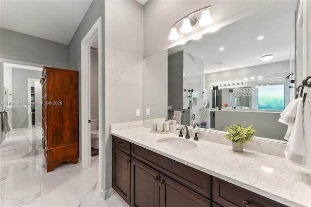 bathroom featuring an enclosed shower, vanity, and toilet