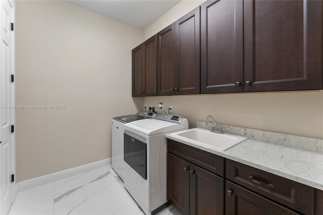 clothes washing area featuring cabinets, independent washer and dryer, and sink