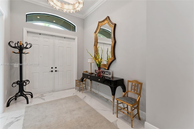 entryway featuring ornamental molding and a notable chandelier