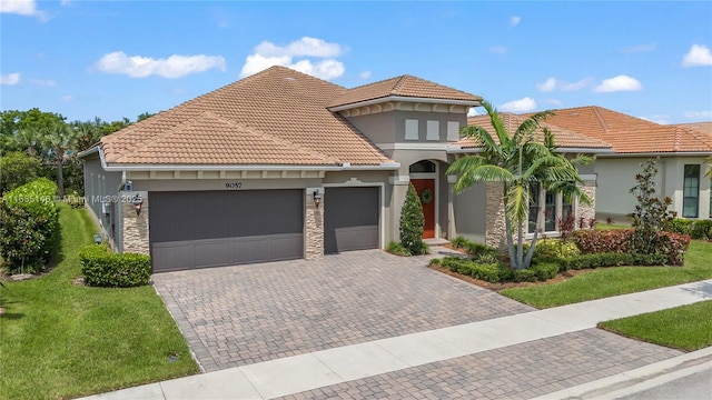 mediterranean / spanish-style home with a garage and a front lawn