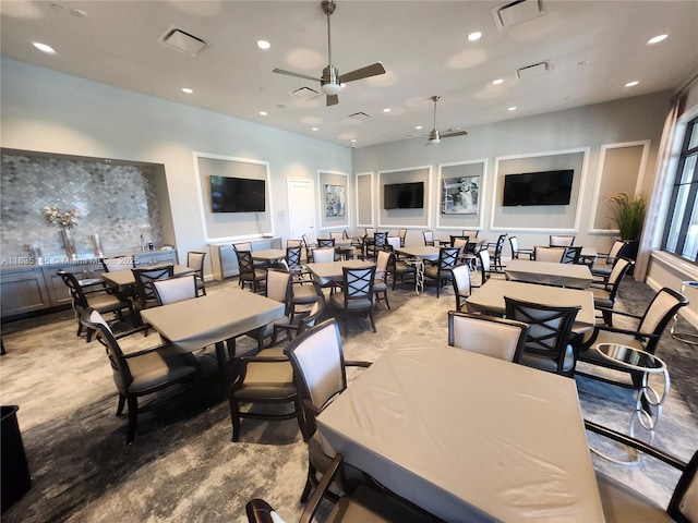 dining room featuring ceiling fan and light carpet