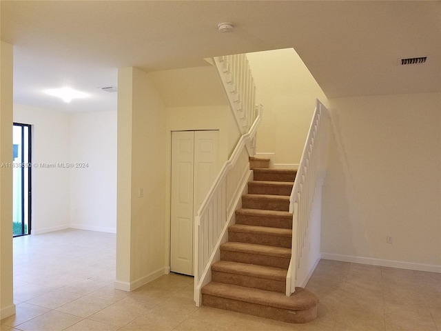 staircase with tile patterned flooring