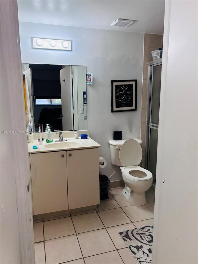 bathroom with walk in shower, tile patterned flooring, vanity, and toilet