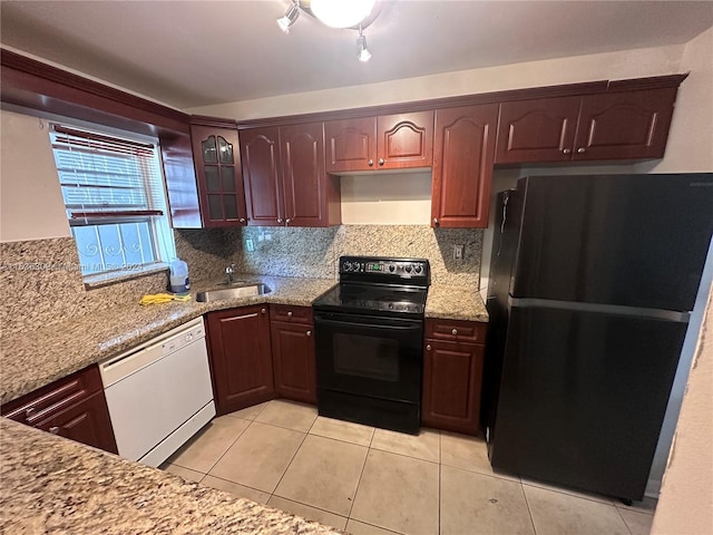 kitchen with black appliances, backsplash, sink, and light tile patterned floors