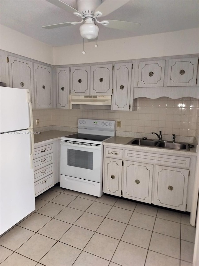 kitchen featuring white appliances, backsplash, sink, light tile patterned floors, and white cabinetry