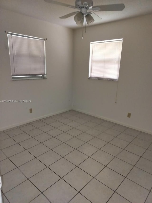 unfurnished room with light tile patterned floors and ceiling fan