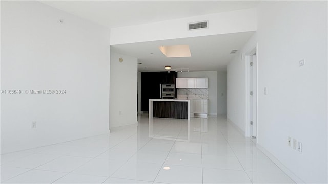 unfurnished living room featuring light tile patterned floors