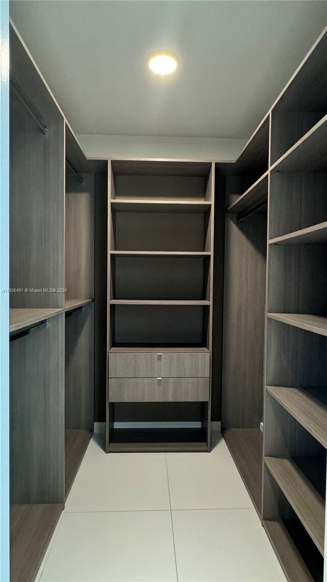 walk in closet featuring tile patterned flooring