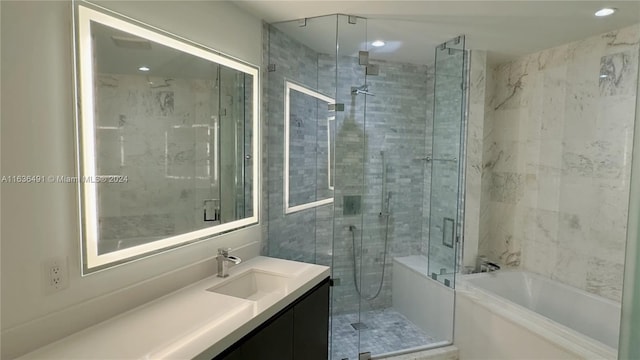 bathroom featuring separate shower and tub and vanity