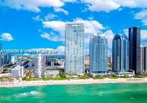 view of city featuring a water view and a beach view