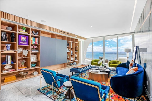 living room with expansive windows, light tile patterned floors, and a water view