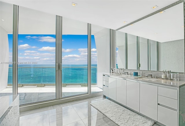 bathroom with double sink vanity, a water view, tile patterned flooring, and decorative backsplash