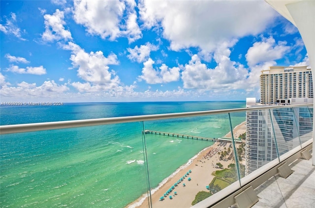 balcony with a beach view and a water view