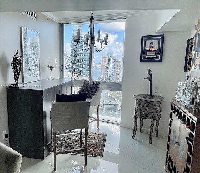 interior space with a water view, ornamental molding, a chandelier, and light tile patterned floors