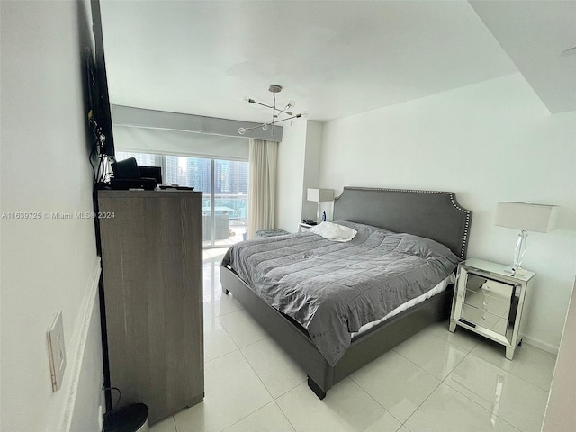 tiled bedroom featuring an inviting chandelier