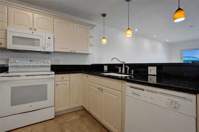 kitchen featuring white appliances, sink, hanging light fixtures, and cream cabinetry