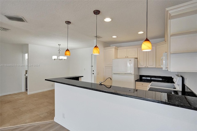 kitchen with kitchen peninsula, a textured ceiling, white appliances, and decorative light fixtures