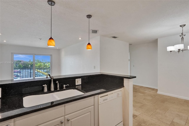 kitchen featuring white cabinetry, sink, hanging light fixtures, white dishwasher, and a textured ceiling